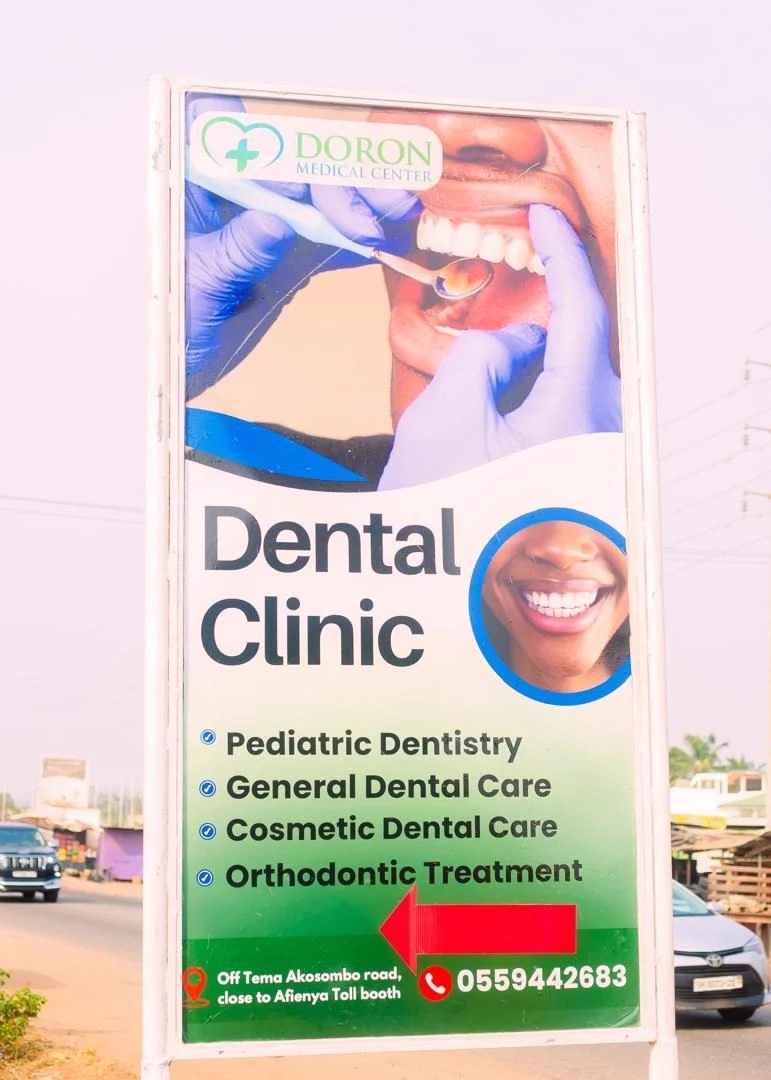 The Doron Medical Center dental clinic sign beside the Tema-Akosombo road near Afienya.